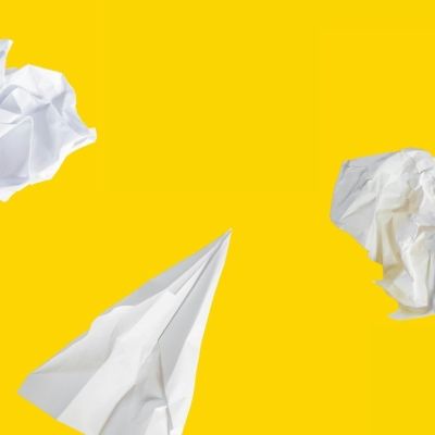 trying new things pieces of paper screwed up on a yellow background