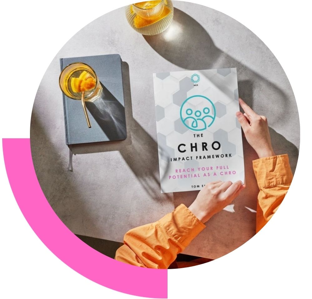 CHRO Framework printed guide by Tom emery on a table with someone just about to open it to read